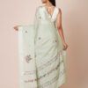 Model wearing a light green pure crepe saree with intricate floral embroidery, perfect for festive occasions
