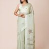 Model wearing a light green pure crepe saree with intricate floral embroidery, perfect for festive occasions