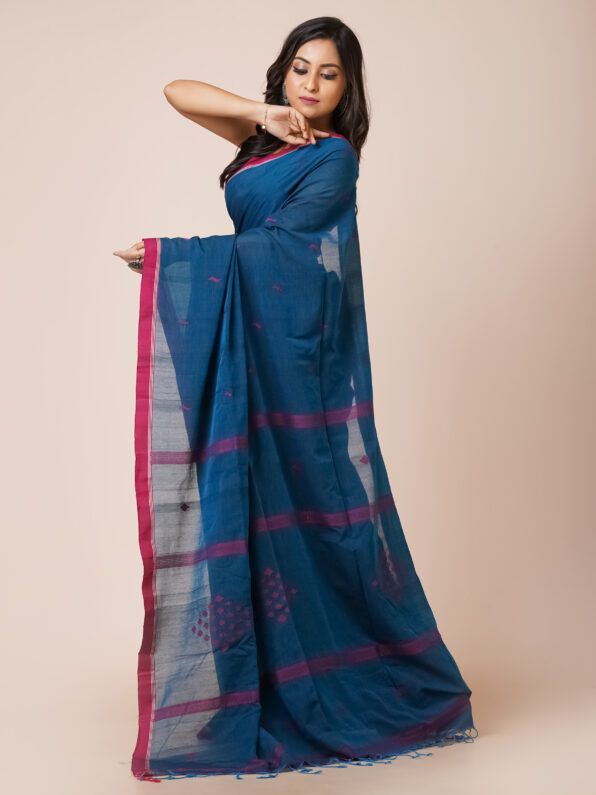 A deep blue khadi cotton saree with red and gold zari border and embroidered motifs.