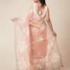 Peach semi organza saree with hand embroidery, floral motifs, silver zari border, and beaded embellishments